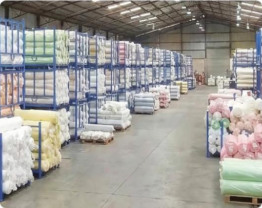 CFAB fabric warehouse with racks of fabric rolls